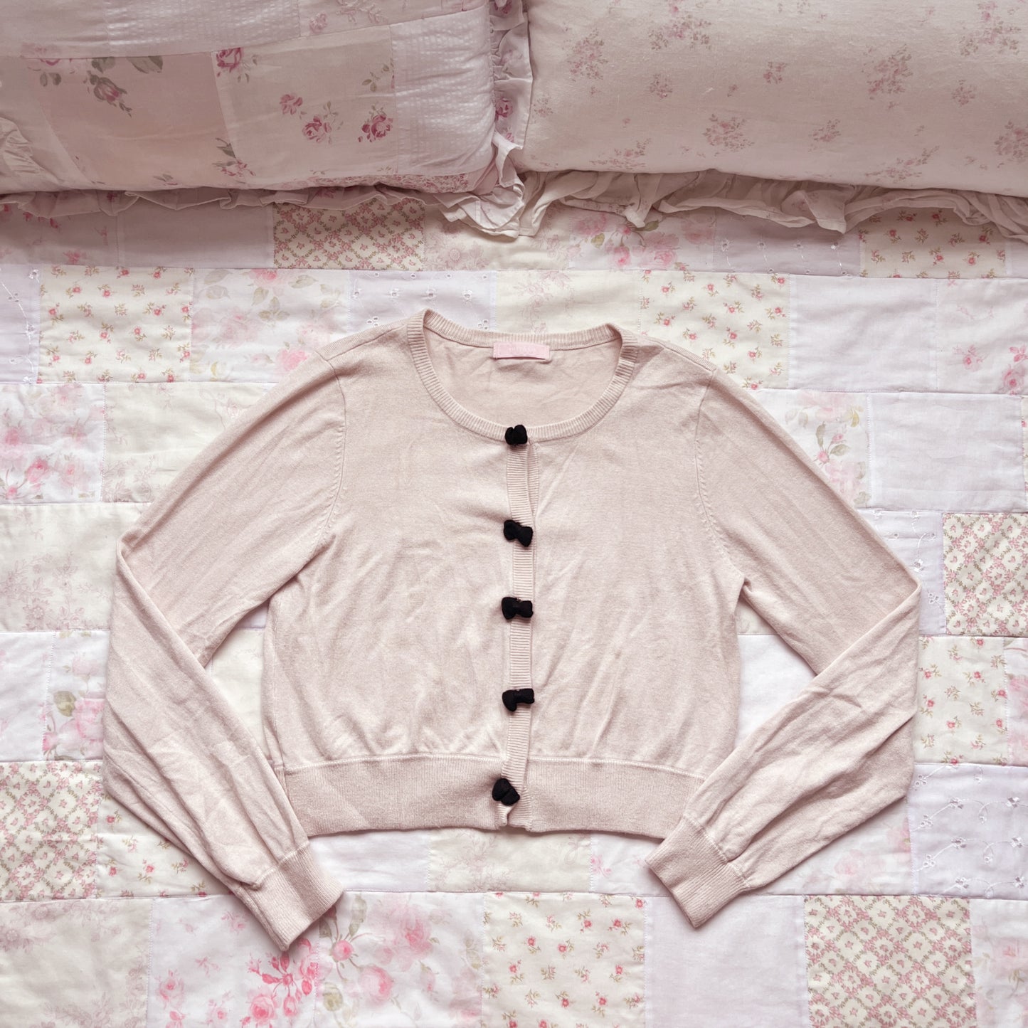soft pink and black cardigan