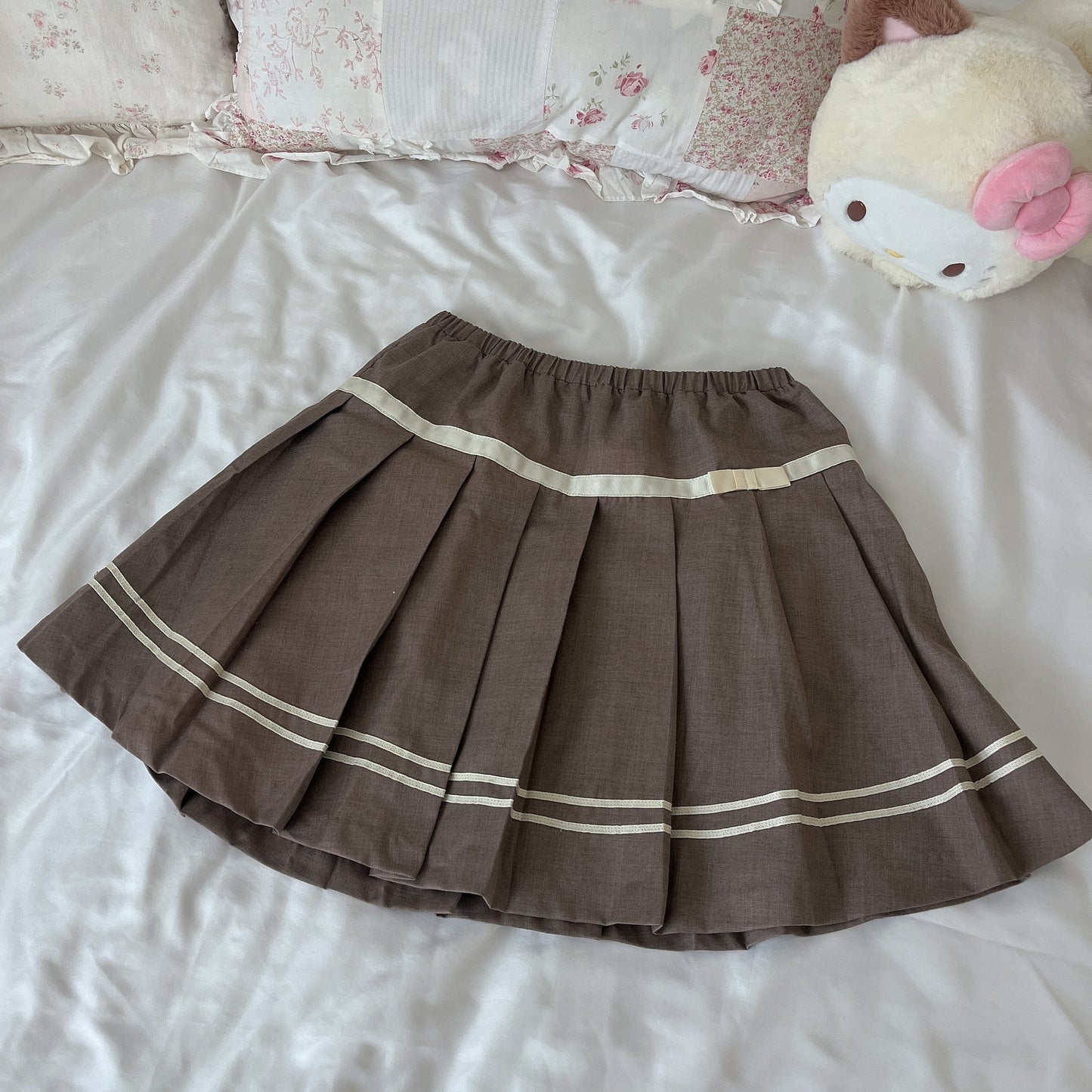 tan pleated ribbon accent skirt