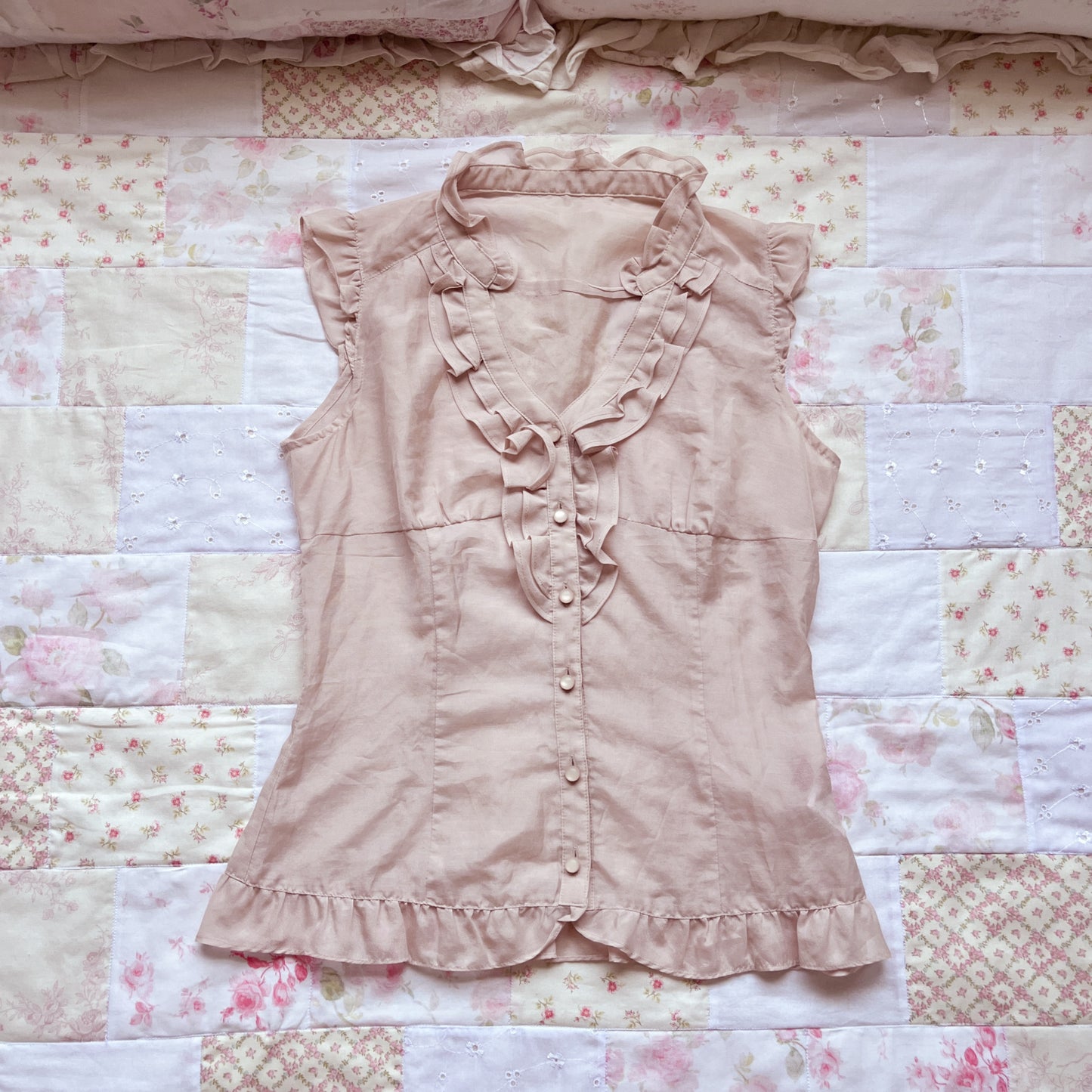 soft pink sleeveless blouse