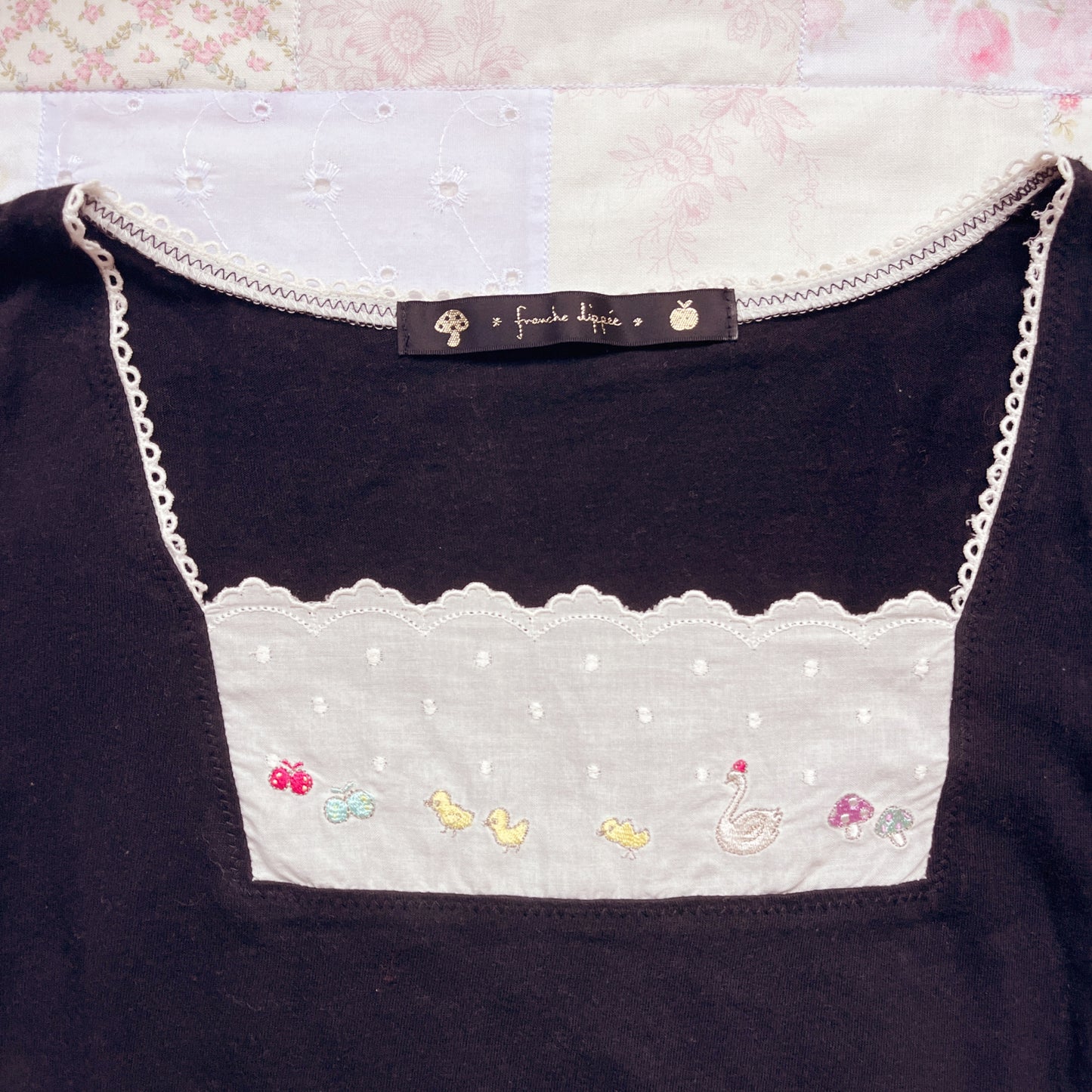 black embroidery accent top