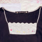 black embroidery accent top