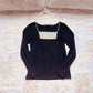 black embroidery accent top
