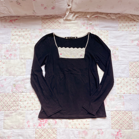 black embroidery accent top
